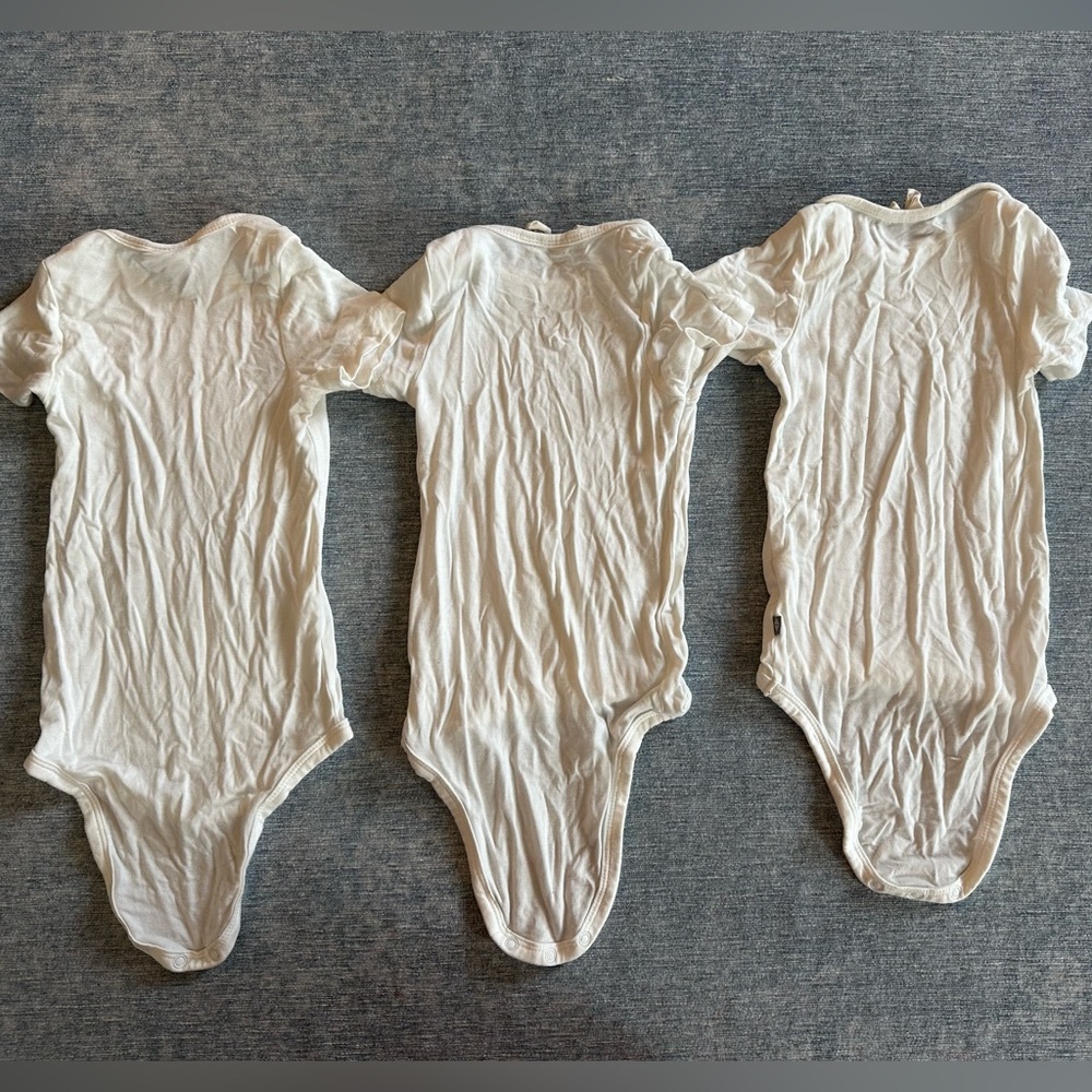 3 cream Kyte baby bodysuits